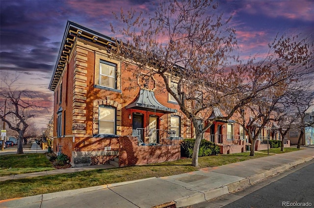 townhome / multi-family property with brick siding