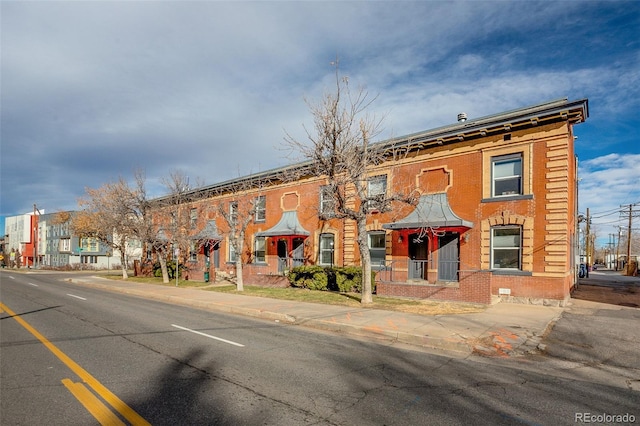 view of front facade featuring crawl space and brick siding