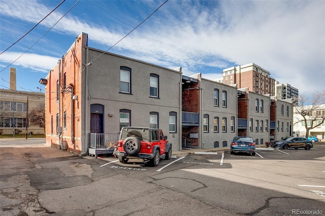 view of building exterior with uncovered parking