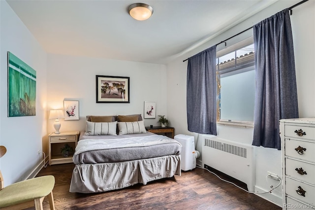 500 E 11th Ave Unit 205, Denver, CO 80203 - bedroom with radiator heating unit and dark wood-style floors