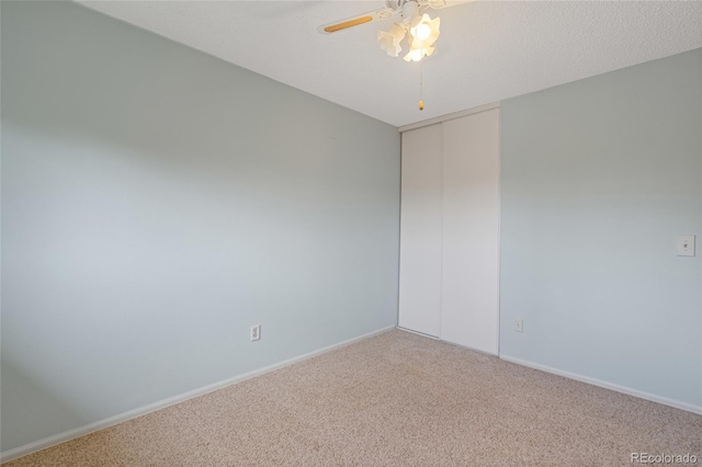 unfurnished room featuring carpet, a ceiling fan, and baseboards