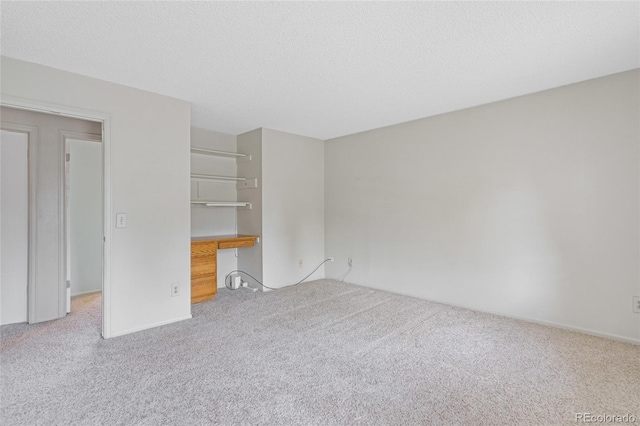 unfurnished bedroom featuring carpet and a textured ceiling