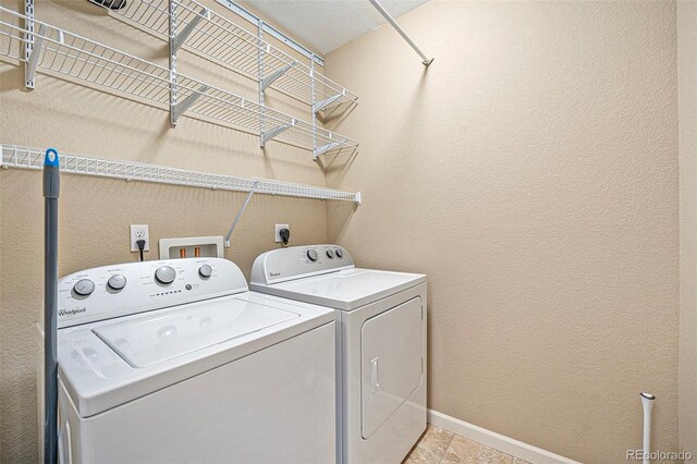 1144 Rockhurst Dr Unit 105, Highlands Ranch, CO 80129 - laundry room featuring separate washer and dryer and baseboards