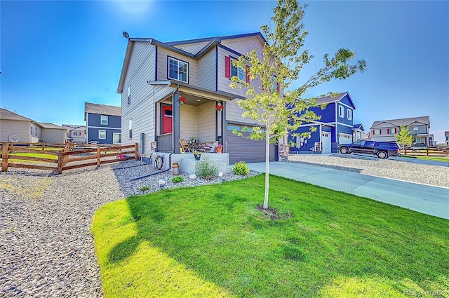 view of front of house featuring a garage and a front lawn