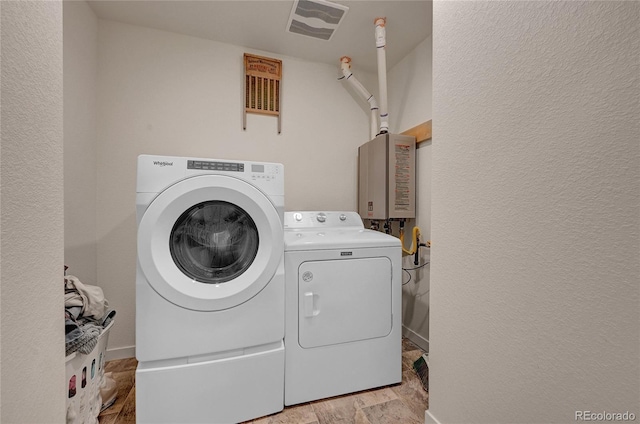 washroom with washer and dryer and light hardwood / wood-style flooring