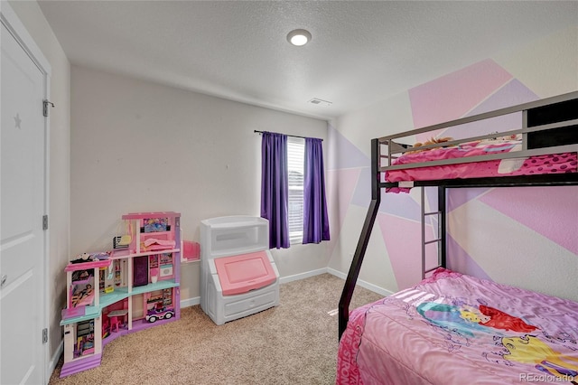 carpeted bedroom with a textured ceiling