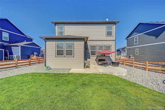 rear view of house with a yard and a patio area