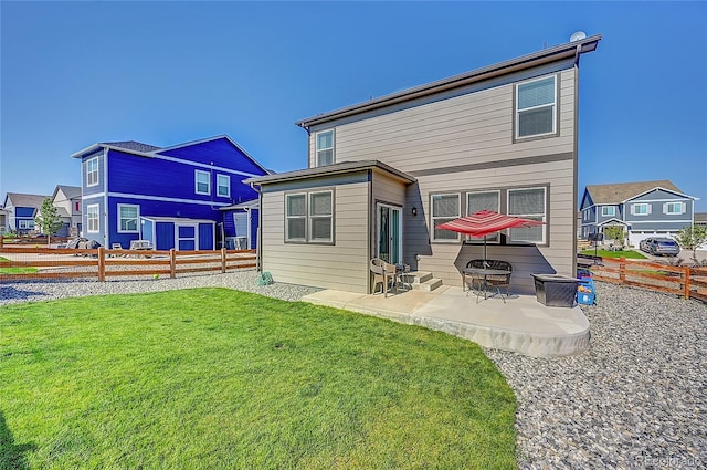 rear view of property with a yard, a patio area, and an outdoor fire pit