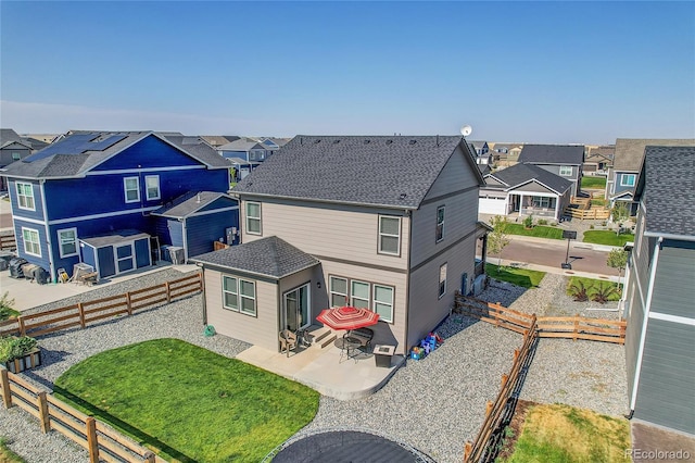 rear view of house featuring a yard and a patio area