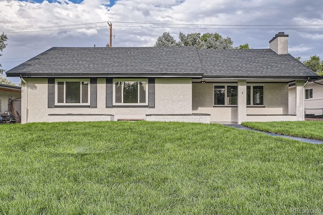 rear view of property with a yard