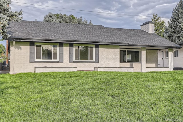 rear view of property featuring a yard