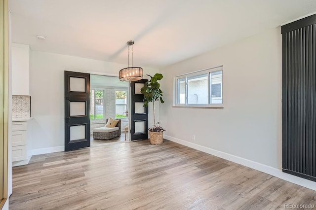 unfurnished dining area featuring a healthy amount of sunlight and light hardwood / wood-style flooring