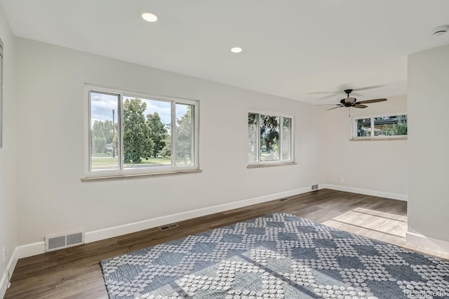 empty room with hardwood / wood-style floors and ceiling fan