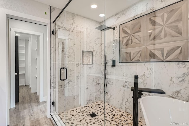 bathroom featuring independent shower and bath and hardwood / wood-style flooring