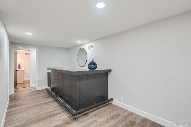 bar featuring light hardwood / wood-style flooring