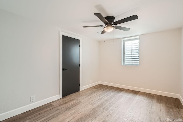 spare room featuring ceiling fan and light wood-type flooring