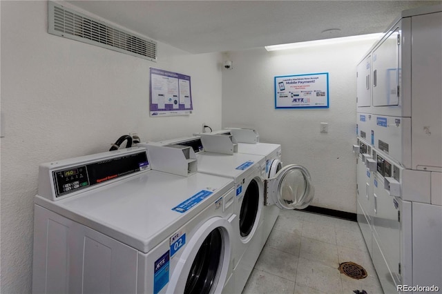 1300 S Parker Rd Unit 110, Denver, CO 80231 - shared laundry room with stacked washer / dryer, independent washer and dryer, and baseboards