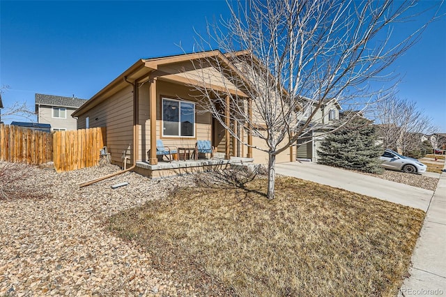 view of front of home featuring driveway and fence