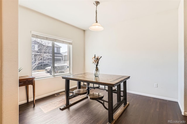 dining area featuring visible vents, baseboards, and dark wood-style flooring