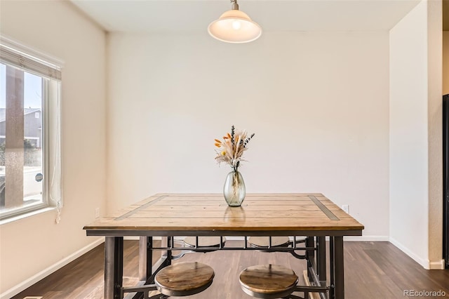 dining room featuring baseboards and dark wood-style flooring