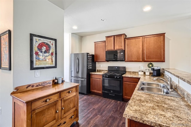 kitchen with brown cabinets, black appliances, a sink, dark wood-style floors, and light countertops