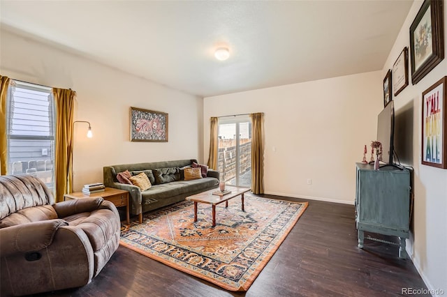 living room featuring baseboards and dark wood finished floors