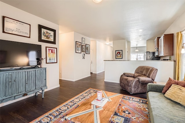 living area with dark wood finished floors and baseboards