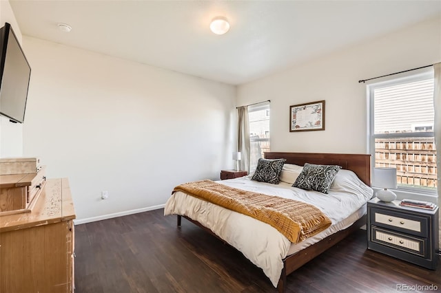 bedroom featuring baseboards and dark wood-style floors