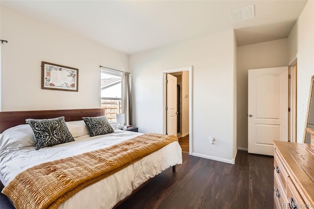 bedroom with baseboards, visible vents, and dark wood-style flooring