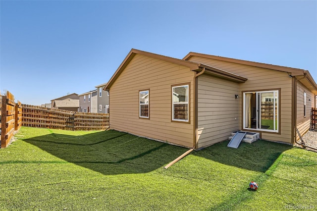 exterior space with a lawn and fence