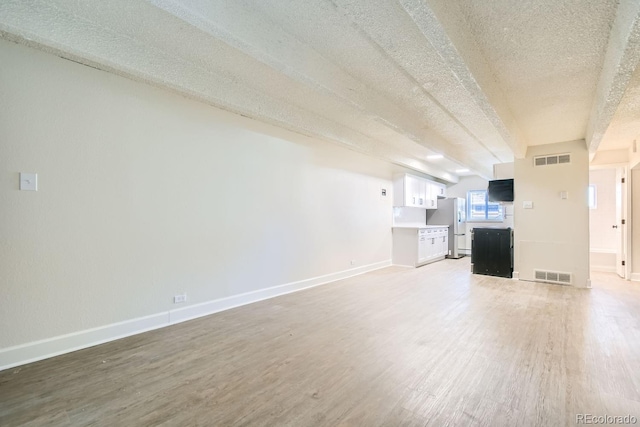 unfurnished living room with hardwood / wood-style flooring