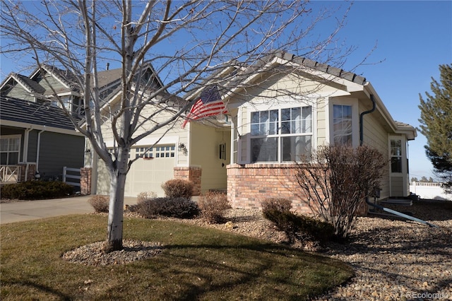 view of property exterior with a garage, concrete driveway, and brick siding