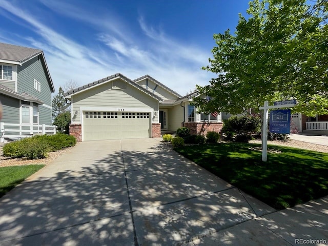 1128 S Duquesne Cir, Aurora, CO 80018 - craftsman house with brick siding, concrete driveway, a garage, and fence