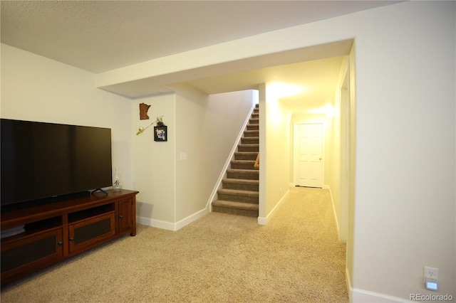 1128 S Duquesne Cir, Aurora, CO 80018 - finished below grade area featuring stairs, light colored carpet, and baseboards