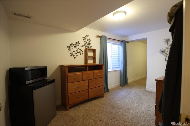 1128 S Duquesne Cir, Aurora, CO 80018 - bedroom with light carpet, baseboards, and refrigerator