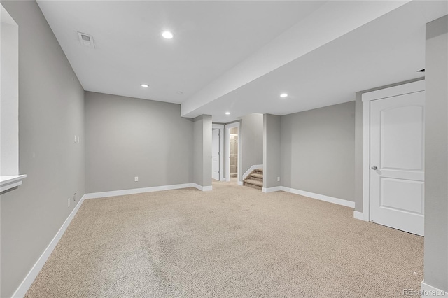 finished below grade area with baseboards, stairs, visible vents, and recessed lighting