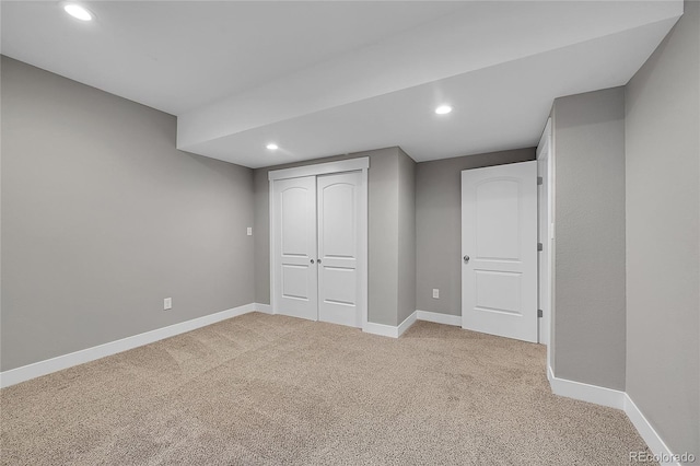 finished basement with recessed lighting, light carpet, and baseboards