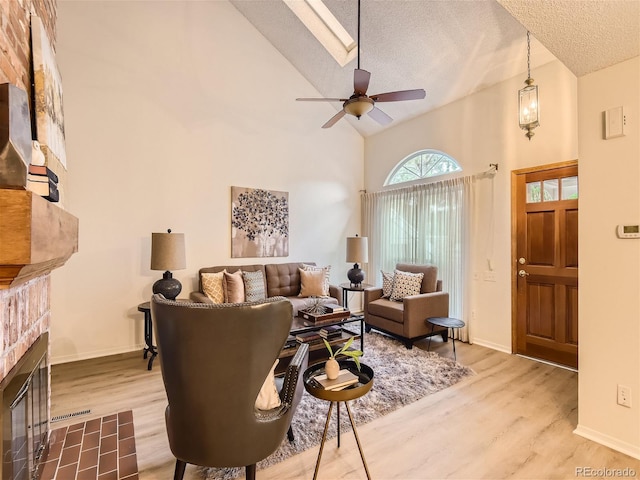 living room with hardwood / wood-style flooring, vaulted ceiling, and a textured ceiling