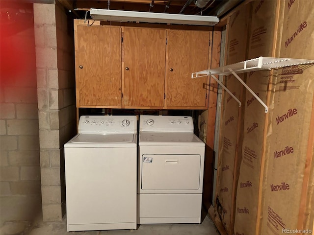 clothes washing area with separate washer and dryer