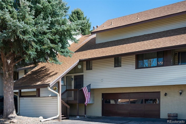 5082 Masheena Ln Unit 4, Colorado Springs, CO 80917 - view of front facade with a garage, a shingled roof, and driveway