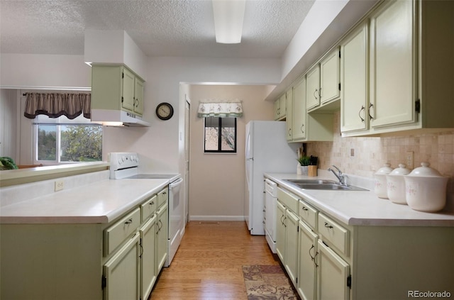 5082 Masheena Ln Unit 4, Colorado Springs, CO 80917 - kitchen with white appliances, a sink, a textured ceiling, tasteful backsplash, and light countertops