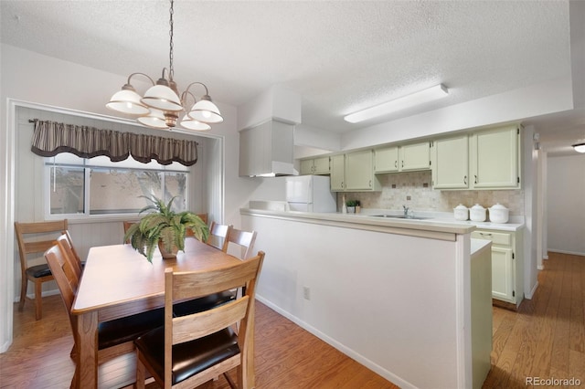 5082 Masheena Ln Unit 4, Colorado Springs, CO 80917 - dining room featuring a chandelier, light wood-style floors, and a textured ceiling