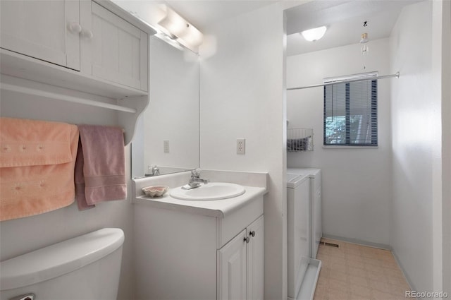 5082 Masheena Ln Unit 4, Colorado Springs, CO 80917 - bathroom featuring washer and clothes dryer, vanity, toilet, tile patterned floors, and baseboards