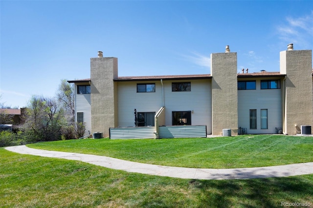 5082 Masheena Ln Unit 4, Colorado Springs, CO 80917 - back of house with a chimney, a yard, and central air condition unit