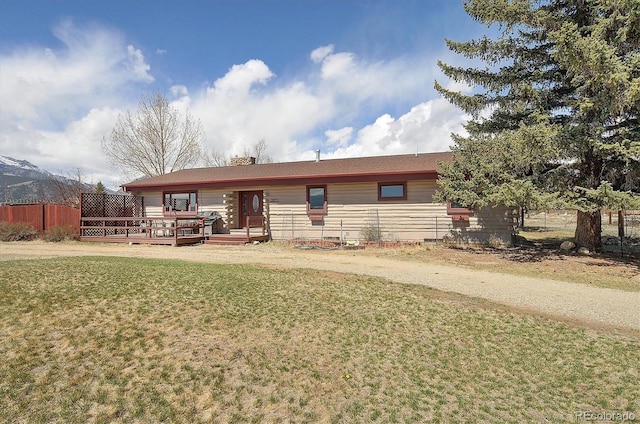 28453 County Road 337, Buena Vista, CO 81211 - single story home featuring fence, a wooden deck, and a front lawn