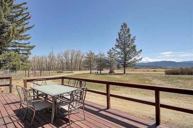 28453 County Road 337, Buena Vista, CO 81211 - wooden terrace featuring a lawn, a mountain view, and outdoor dining space