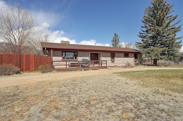28453 County Road 337, Buena Vista, CO 81211 - back of house featuring fence, a chimney, a lawn, and a deck