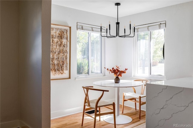 dining space featuring a chandelier and light wood-type flooring