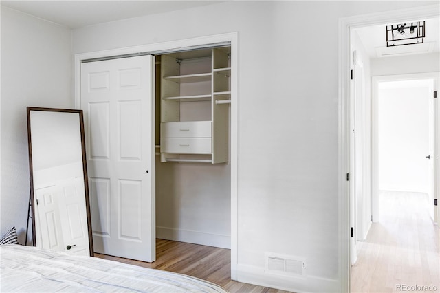 unfurnished bedroom with light hardwood / wood-style floors and a closet