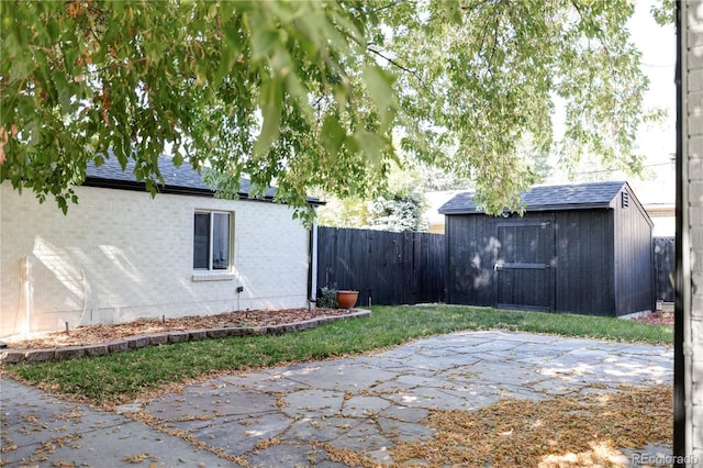 view of yard with a patio area and a storage shed